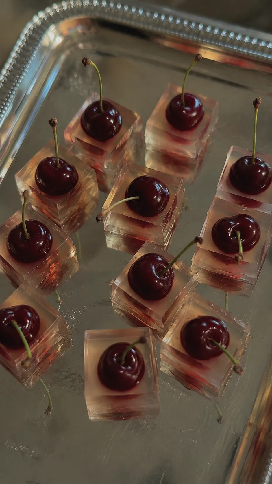 Sour-cherry cubes on a silver serving tray